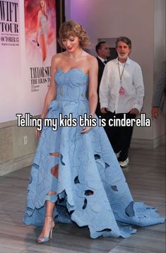 a woman in a blue dress standing on the red carpet with her legs ripped off