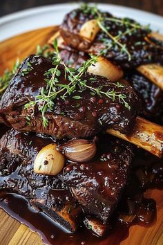 some meat and potatoes on a plate with garnishes in the middle, ready to be eaten