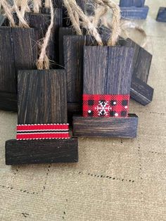 several pieces of wood sitting on top of a table next to twine ropes and burlocks