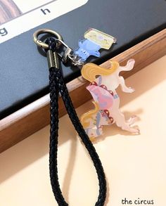 a keychain with an image of a horse on it and a book in the background