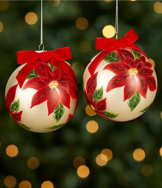 two red and white christmas ornaments hanging from strings