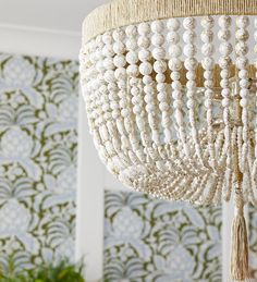 a white chandelier hanging from the ceiling in a room with wallpapered walls