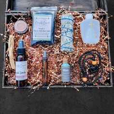 an assortment of personal care products in a metal box on top of wood shaving