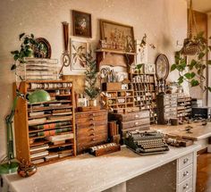 an old fashioned desk with lots of books and other items on it, including a typewriter