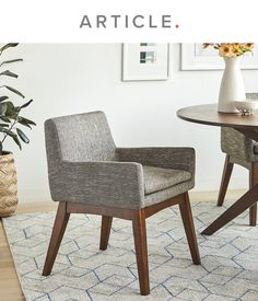 two chairs sitting on top of a rug next to a table