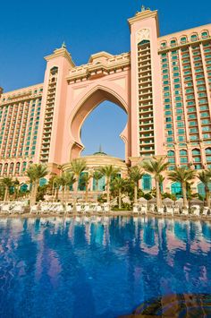 a large building with a pool in front of it