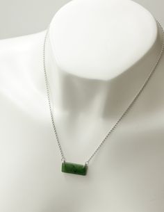 "Simple and bold, this modern green jade bar necklace will help soothe the heart chakra and protect you from negative energy. Jade is known as healing kidney stone too. This green nephrite jade is hand carved and polished to a high shine. Stone & Dimensions: Natural A grade Canadian Nephrite Jade set in 925 sterling silver 18\" chain Size about 1\" x 1/2\" Please note, there are natural black iron flecks within the jade. 100% genuine jade. We work with nephrite jade in its natural form. - Gi Engraved Jade Necklace For Gift, Green Square Pendant Necklace In Minimalist Style, Green Rectangular Pendant Jewelry For Everyday, Minimalist Green Necklace With Square Pendant, Green Square Pendant Minimalist Necklace, Minimalist Green Square Pendant Necklace, Modern Green Rectangular Pendant Jewelry, Elegant Nickel-free Jade Necklaces, Carved Jade Necklace In Silver