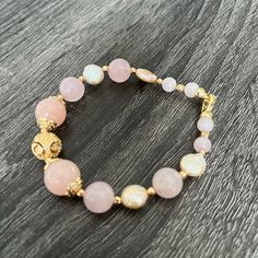 Women Bracelet Made With Pose Quartz, Pearl And Gold Plated Findings. Dainty Pink Bracelet With Natural Stones, Dainty Pink Natural Stone Bracelet, Pink Single Strand Beaded Bracelet For Gift, Adjustable Feminine Crystal Bracelet, Pink Single Strand Beaded Bracelet Gift, Pink Single Strand Beaded Bracelet As Gift, Elegant Gold Beaded Bracelets With Rose Quartz, Adjustable Pink Single Strand Beaded Bracelets, Handmade Elegant Stretch Bracelet