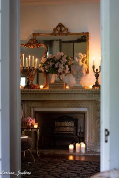 the fireplace is decorated with candles and flowers