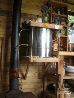 a large pot sitting on top of a stove in a kitchen next to a shelf