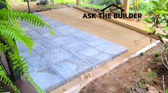 an image of a patio being built in the yard with plants and trees around it