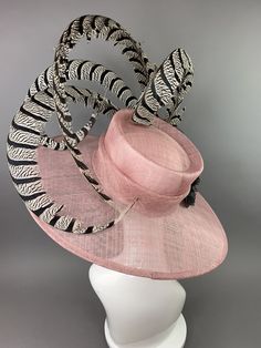 "Blush Sinamay Hat with black and white Lady Amherst feathers and black roses. ♥Hat base fits 22.5\" and smaller with internal elastic band. ♥Ultra Light & comfortable to wear. ♥Packed and shipped in a sturdy box with special love & care to ensure a safe delivery. ♥Includes a hat care card with instructions on how to care for & keep your piece beautiful. ♥Over 14,000 pieces sold & 2,000 5 star reviews. Our \"Hive Girls\" come back year after year for their next hat or fascinator. Adjustable Evening Hat With Feather Trim, Fitted Hats With Feather Trim And Short Brim, Spring Top Hat With Feather Trim, Short Brim Costume Hats With Feather Trim For Races, Feathered Hat For Royal Ascot Races, Fitted Feather Hat For Royal Ascot, Feathered Top Hat For Races, Chic Feathered Mini Hats For Races, Feathered Costume Hat For Races With Short Brim