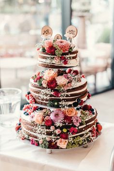 a wedding cake decorated with flowers on a table