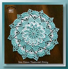 a crocheted doily on a wooden table with the words sea foam teal