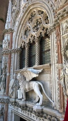 a statue of a lion on the side of a building