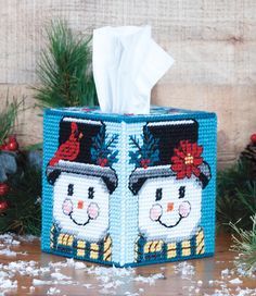 a tissue box with two snowmen on it