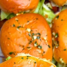 a close up view of some tomatoes and lettuce with seasoning on them