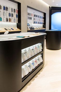 the inside of a cell phone store with many items on display in front of them