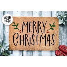 a door mat with the words merry christmas written on it next to red shoes and succulents