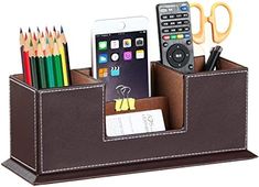 a cell phone, pencils, and other items in a leather holder with handles