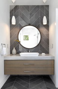 a bathroom with a sink, mirror and lights