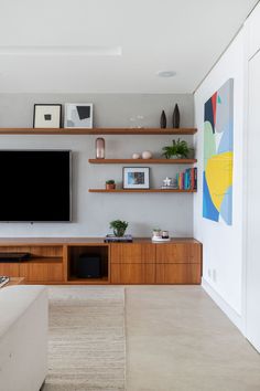 a flat screen tv mounted on a wall in a living room