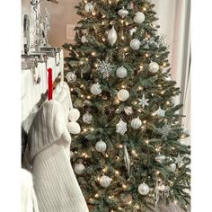 a christmas tree with stockings hanging from it