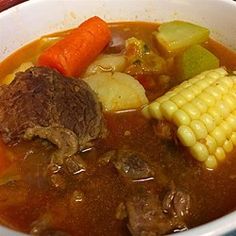 a white bowl filled with soup and vegetables