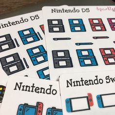 four nintendo stickers sitting on top of each other