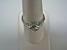 "For Sale: (1) H108 Gorgeous Diamond Ring in 14k White Gold from 1930's PLEASE READ ENTIRE DESCRIPTION BEFORE PURCHASING Please see pictures for more details! This stunning ring features a center 0.06 ct diamond. This is a beautiful filigree mounting down the side. The shank is decorated half way down. The ring is not stamped 14k, but was tested for it. This ring is from the 1930's. A beautiful piece for a any special occasion! What a great Gift! Specifics: *14k White Gold *Center Diamond approx Classic Platinum Diamond Ring Collectible, Antique Platinum Jewelry For Formal Occasions, Collectible Heirloom Solitaire Ring, Vintage Platinum Diamond Ring For Formal Occasions, Vintage Platinum Diamond Ring For Formal Events, Classic Collectible Rings With Diamond Cut, Estate Style Oval Platinum Rings, Antique Engraved Round Band Ring For Formal Occasion, Victorian Platinum Jewelry For Formal Occasions