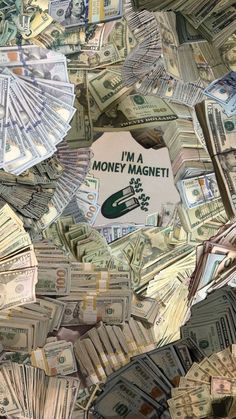 the money is piled up and ready to be used as an advertisement for i'm a money magnet