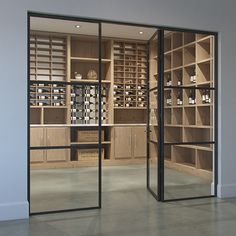 an empty room with glass doors and shelves