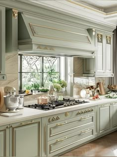 a kitchen with green cabinets and white counter tops, gold trimmings on the windows