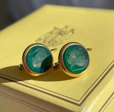 DESIGNER 18K ROMAN ARMORIAL INTAGLIO EARRINGS, SIGNED, 0.75". MIDCENTURY ITALIAN LUXURY BRAND, GENIO & BREVETTI', WERE A HIGH-END ITALIAN DESIGN COMPANY THAT WERE KNOWN FOR THEIR LUXURY ART GLASS.  THEY DID CREATE SOME JEWELRY, ALSO. CARVED GREEN CHRYSOPRASE CHALCEDONY, MOUNTED IN HEAVY SOLID 18K YELLOW GOLD. DORMEUSES/LEVERBACK SETTING. VERY WELL MADE.  WEIGHT:  4.5 grams DIMENSIONS:  0.75" x 0.5" INTAGLIOS: Carved Green Chrysoprase Chalcedony  6.05mm each HALLMARKS:  Genio & Brevetti 750 CONDITION:  some surface wear. PROVENANCE:  a Florida estate P599 Italian Luxury Brands, Floral Studs, Luxury Art, Italian Luxury, Design Company, Italian Design, Cross Pendant, Luxury Brand, Beautiful Earrings