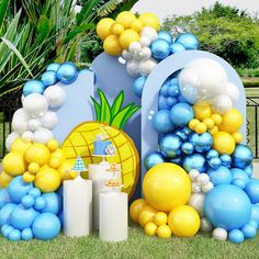 balloons and pineapples are arranged on the lawn