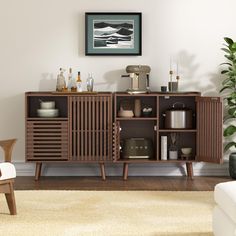 a living room with furniture and decor on the wall, including a chair and sideboard