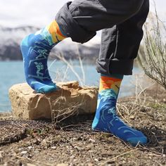 Gear up for your next adventure with these exhilarating socks that are sure to elevate your spirits. Featuring a playful design of hikers scaling a steep slope and the clever phrase 'Adjust Your Altitude' on the soles, these socks are not just stylish, they're also a peak experience! Perfect for any mountain lover who wants to put their best foot forward.These socks are not only trail-tested for comfort but also adventure-approved for fun. Made from a soft and stretchy cotton/nylon blend, they'l Mountain Lover, Funny Socks, Novelty Socks, Designer Socks, Playful Design, Climbing, Socks, Womens Sizes, Design