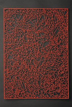 an abstract painting with red lines on black paper