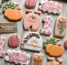 many decorated cookies are displayed on a table