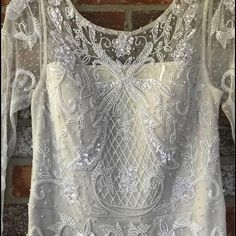 Brand New, Never Worn, Beaded Wedding Dress. Still Has Tags Attached! It’s A Size 4, And Hasn’t Been Altered At All. It Has Been Stored Safely In The Garment Bag From The Dress Shop The Whole Time. I Don’t Have A Need For It Anymore. Price Is Negotiable. Sequin Wedding Dress With Fitted Bodice, Fitted White Gown With Pearl Embroidery, Wedding Dress With Beaded Fitted Bodice, Formal White Wedding Dress With Pearl Embroidery, Fitted Floor-length Wedding Dress With Pearl Embroidery, Formal White Sequined Wedding Dress, Fitted Mother Of The Bride Dress With Intricate Embroidery, Floor-length Fitted Wedding Dress With Pearl Embroidery, Elegant Dresses With Intricate Embroidery For Wedding Reception