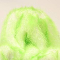 a lime green fur hat on a white background