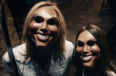 two women wearing masks pose for a photo