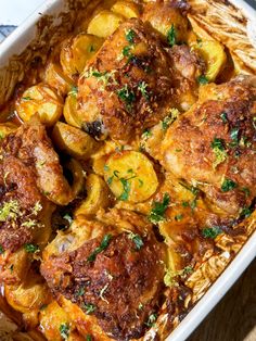 a casserole dish with chicken, potatoes and parsley