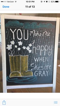 a chalkboard with an image of a boot and raindrops on it that says, you make me happy when skies are gray