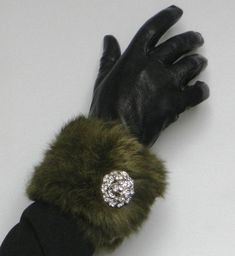 Genuine Vintage Rabbit Fur  (70's) pieces from Milano, handmade  pair of cuffs embellished with a pair of hand made brooch - Cufflinks made from rhinestones (1.5 Inches in diameter). The adjustable cuffs are fitted with 2 magnetic press dud fasteners so as to be worn either as a bracelet (one size) or as cuffs on a jacket a coat or dress (larger size). See photo above. The magnificent forest green hue of this long hair rabbit fur give it a truly vintage appeal    Dress up your little black dress or vintage jacket. Fully lined. Length: 12 Inches  30 cm Width:   4 Inches    10cm Classic Cuff Jewelry For Party, Unique Cuff Bracelet For Formal Occasions, Elegant Jewelry For Anniversary In Winter, Elegant Clip-on Brooches For Formal Occasions, Vintage Cuff Bracelets For Parties, Handmade Green Brooches For Formal Occasions, Handmade Green Brooch For Formal Occasions, Formal Cuff Bracelet, Handmade Cuff Bracelet For Formal Occasions