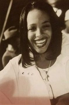 a black and white photo of a woman smiling