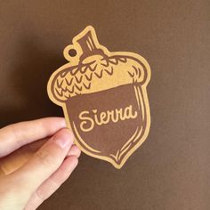 a hand holding a sticker with the word sierra on it and a shield in the middle