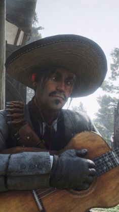 a man wearing a sombrero and holding a guitar