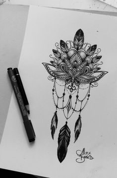 a drawing of a dream catcher with feathers and beads on it's head, next to a marker pen