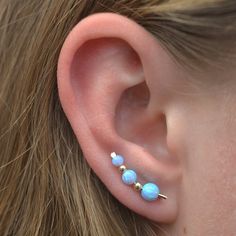 "What is not to love about this gorgeous Opal Graduated Gem Ear Climber! The colors are much more stunning than this photograph can show. It fits gracefully up the natural shape of your ear with shimmer and pizzazz! This earring only requires one standard ear piercing. It is shaped like a bobby pin, and the wire on the back of the ear holds the ear pin in place, comfortably and securely. We use synthetic opals laboratory made, and slide from 3mm to 5mm gems onto a 19 gauge sterling or gold fille Ear Pins Earrings, Gold Ear Climbers, Tiny Gold Studs, Turquoise Earring, Ear Pin, Silver Ear Climbers, Ear Crawler, Ear Crawlers, Ear Climber